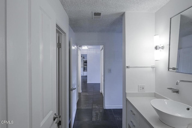 631 Wilcox Ave Unit 2E, Los Angeles, CA 90004 - bathroom with a textured ceiling, vanity, and tile patterned flooring