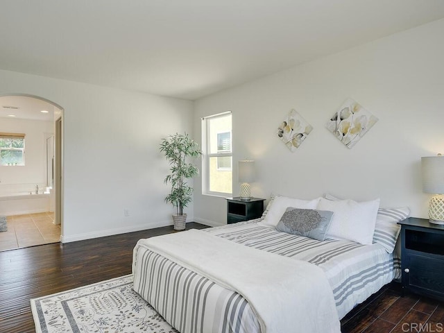 11615 Trailbrook Ln, San Diego, CA 92128 - bedroom with arched walkways, wood finished floors, and baseboards