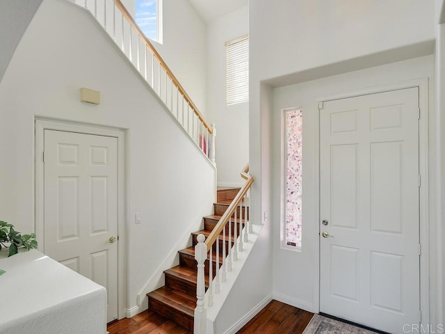 11615 Trailbrook Ln, San Diego, CA 92128 - foyer featuring stairs, dark wood-style floors, a towering ceiling, and baseboards