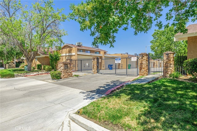 44156 30th St W, Lancaster, CA 93536 - view of front of house featuring a gate, a fenced front yard, and stone siding