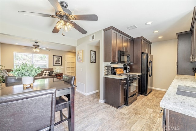 44156 30th St W, Lancaster, CA 93536 - kitchen with black appliances, dark brown cabinetry, open floor plan, light wood-style flooring, and a ceiling fan