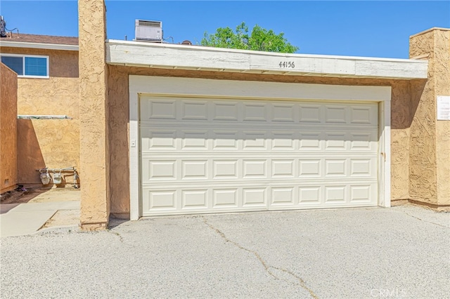 44156 30th St W, Lancaster, CA 93536 - garage featuring driveway and central AC