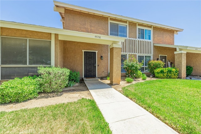 44156 30th St W, Lancaster, CA 93536 - view of front of property featuring stucco siding and a front lawn