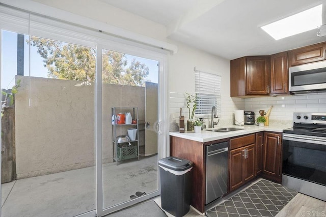 1450 Melrose Ave Unit 25, Chula Vista, CA 91911 - kitchen with appliances with stainless steel finishes, a sink, light countertops, and backsplash