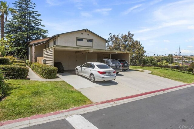 1450 Melrose Ave Unit 25, Chula Vista, CA 91911 - view of front of property featuring an attached carport, stucco siding, and driveway