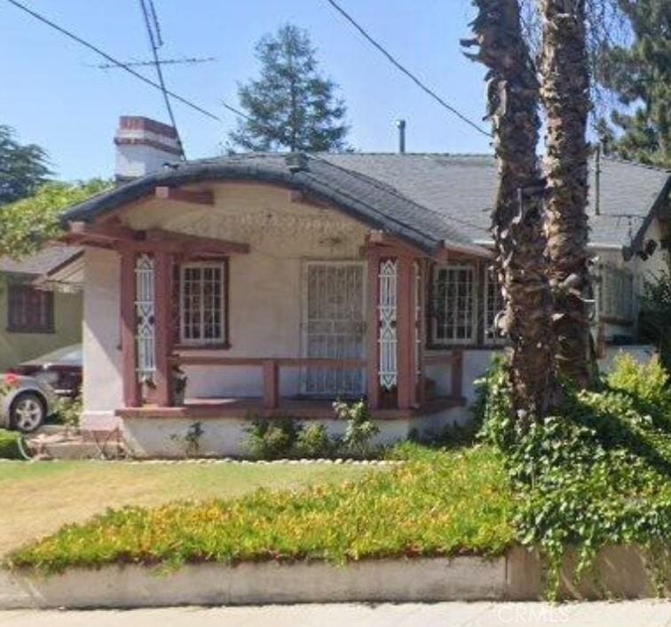 1049 E Claremont St, Pasadena, CA 91104 - bungalow featuring covered porch, a chimney, a front lawn, and roof with shingles
