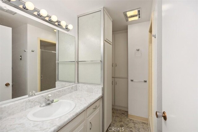 542 Via Estrada Unit A, Laguna Woods, CA 92637 - bathroom with vanity and a shower with shower door