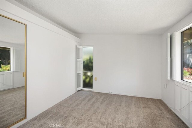 542 Via Estrada Unit A, Laguna Woods, CA 92637 - carpeted empty room featuring a textured ceiling