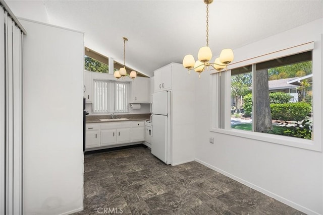 542 Via Estrada Unit A, Laguna Woods, CA 92637 - kitchen featuring a chandelier, freestanding refrigerator, a sink, white cabinets, and lofted ceiling