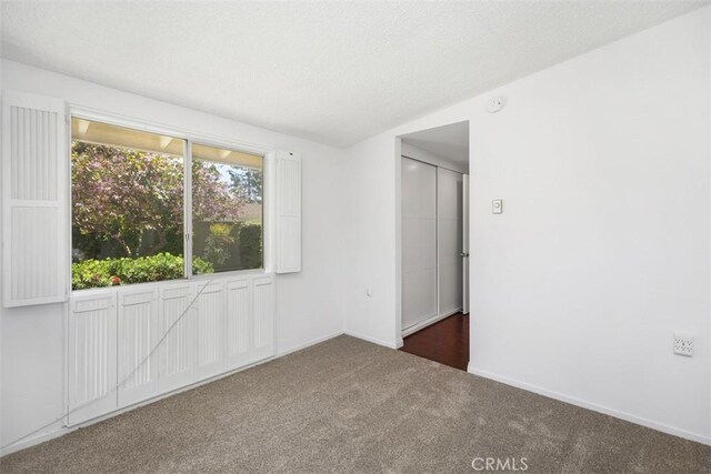 542 Via Estrada Unit A, Laguna Woods, CA 92637 - carpeted spare room with baseboards, a textured ceiling, and a smoke detector