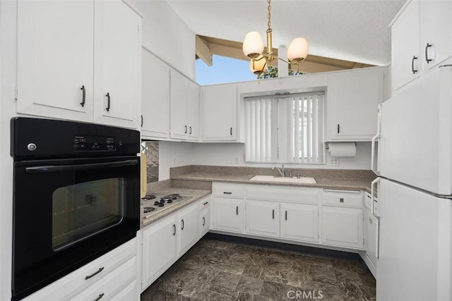 542 Via Estrada Unit A, Laguna Woods, CA 92637 - kitchen featuring freestanding refrigerator, oven, lofted ceiling, a sink, and white cabinetry