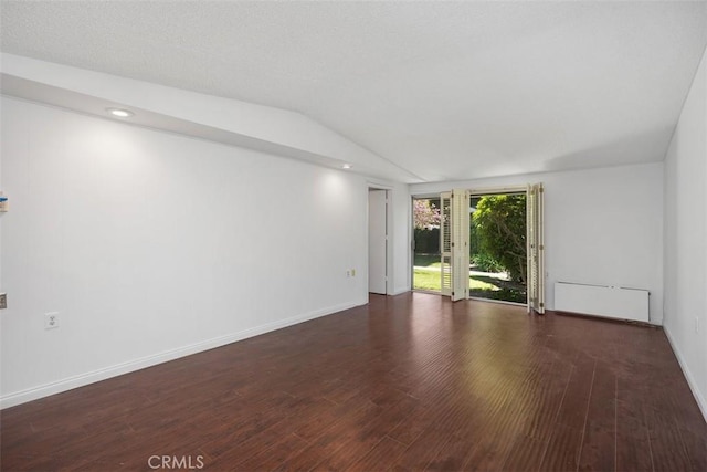 542 Via Estrada Unit A, Laguna Woods, CA 92637 - empty room featuring wood finished floors, lofted ceiling, baseboards, and radiator heating unit