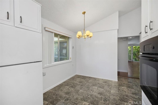 542 Via Estrada Unit A, Laguna Woods, CA 92637 - unfurnished dining area with vaulted ceiling, a chandelier, and baseboards