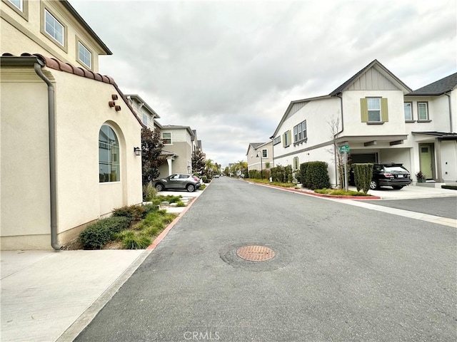 403 Aura Dr, Costa Mesa, CA 92626 - view of asphalt road featuring a residential view
