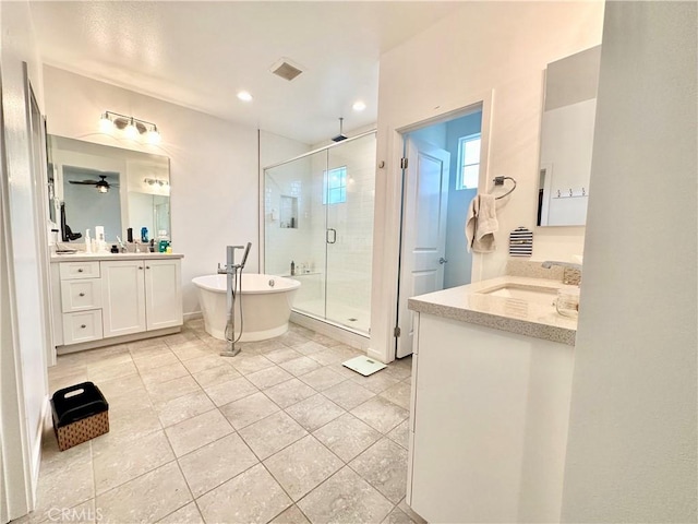 403 Aura Dr, Costa Mesa, CA 92626 - full bath with a stall shower, two vanities, tile patterned flooring, a freestanding tub, and recessed lighting