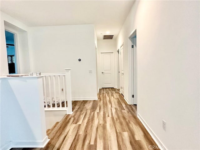 403 Aura Dr, Costa Mesa, CA 92626 - hallway with an upstairs landing, wood finished floors, and baseboards