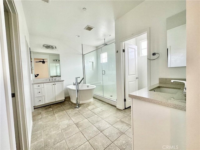 403 Aura Dr, Costa Mesa, CA 92626 - bathroom featuring a shower stall, two vanities, and a freestanding tub