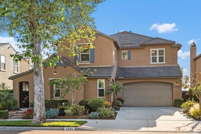 2386 Lapis Rd, Carlsbad, CA 92009 - view of front of home with concrete driveway, stucco siding, an attached garage, and a tile roof