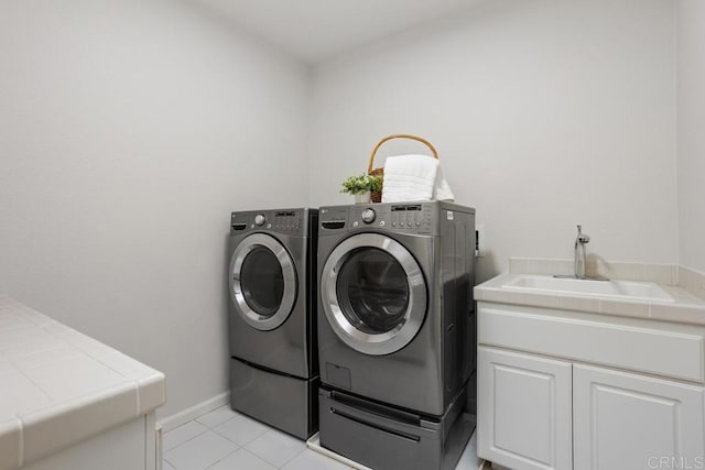 2386 Lapis Rd, Carlsbad, CA 92009 - washroom with washer and clothes dryer, light tile patterned flooring, and cabinet space