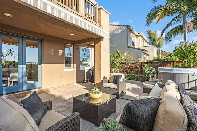 2386 Lapis Rd, Carlsbad, CA 92009 - fenced backyard featuring a hot tub, a patio area, outdoor lounge area, and french doors