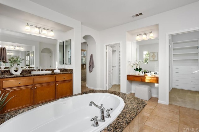 2386 Lapis Rd, Carlsbad, CA 92009 - bathroom with a bath, vanity, a walk in closet, tile patterned floors, and baseboards