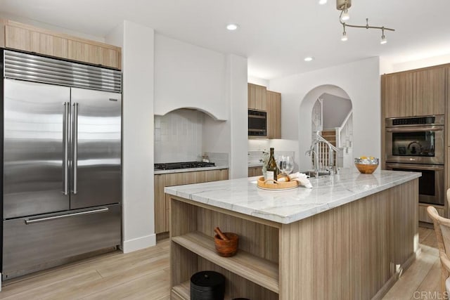 2386 Lapis Rd, Carlsbad, CA 92009 - kitchen with appliances with stainless steel finishes, modern cabinets, open shelves, arched walkways, and recessed lighting