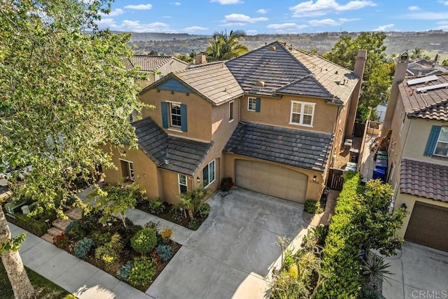 2386 Lapis Rd, Carlsbad, CA 92009 - view of front of house with stucco siding, an attached garage, driveway, and a chimney