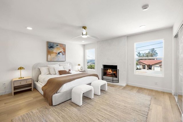 1711 Alhudson Dr, Escondido, CA 92029 - bedroom featuring light wood finished floors, a large fireplace, baseboards, a ceiling fan, and recessed lighting