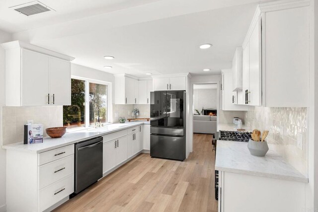 1711 Alhudson Dr, Escondido, CA 92029 - kitchen featuring stainless steel appliances, a sink, decorative backsplash, light wood-style floors, and white cabinetry