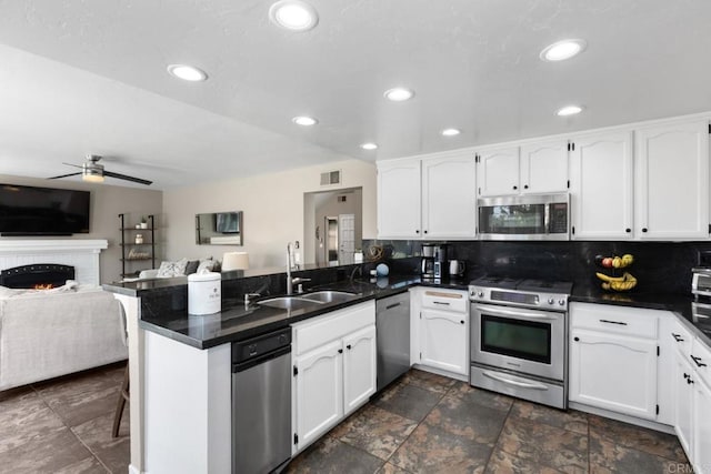 11171 Alejo Pl, San Diego, CA 92124 - kitchen featuring stainless steel appliances, a peninsula, a ceiling fan, dark countertops, and recessed lighting