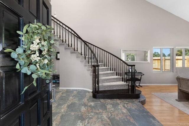 11171 Alejo Pl, San Diego, CA 92124 - entryway with high vaulted ceiling, stairway, baseboards, and wood finished floors