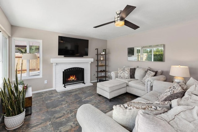 11171 Alejo Pl, San Diego, CA 92124 - living area with ceiling fan, baseboards, a brick fireplace, and dark stone finish flooring