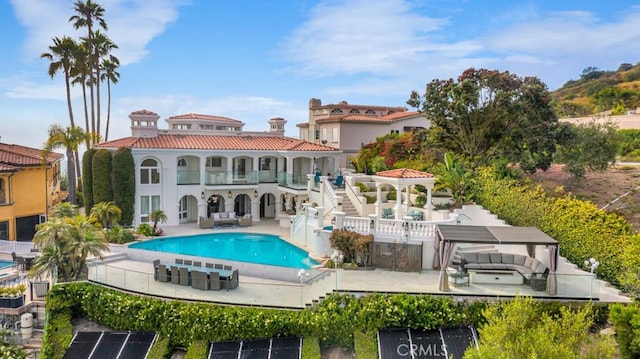 8 Saint Tropez, Laguna Niguel, CA 92677 - back of property with a balcony, an outdoor pool, a patio area, stucco siding, and stairway