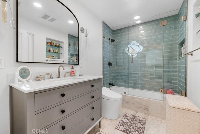 8 Saint Tropez, Laguna Niguel, CA 92677 - full bathroom featuring toilet, vanity, recessed lighting, marble look tiles, and shower / bath combination with glass door