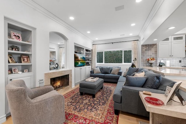 8 Saint Tropez, Laguna Niguel, CA 92677 - living room with crown molding, a premium fireplace, recessed lighting, light wood-type flooring, and built in features