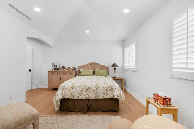 8 Saint Tropez, Laguna Niguel, CA 92677 - bedroom featuring light wood-style flooring, arched walkways, recessed lighting, baseboards, and lofted ceiling