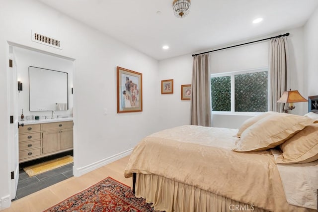8 Saint Tropez, Laguna Niguel, CA 92677 - bedroom featuring light wood-style floors, a sink, recessed lighting, ensuite bath, and baseboards