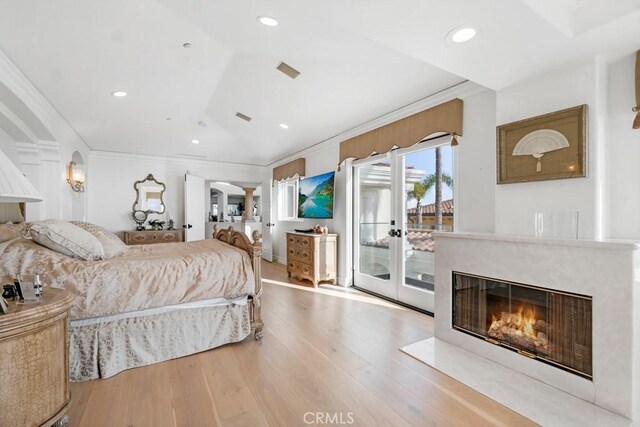 8 Saint Tropez, Laguna Niguel, CA 92677 - bedroom with access to outside, ornamental molding, french doors, wood finished floors, and a fireplace