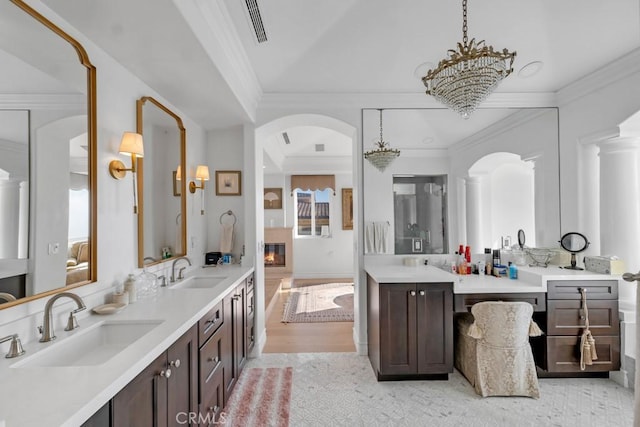 8 Saint Tropez, Laguna Niguel, CA 92677 - bathroom featuring double vanity, crown molding, a chandelier, and wood finished floors