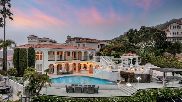 8 Saint Tropez, Laguna Niguel, CA 92677 - rear view of property with stairway, an outdoor hangout area, an outdoor pool, a patio, and a balcony