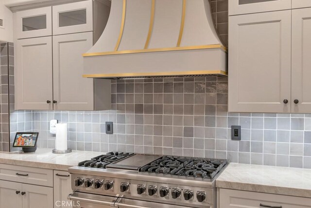 8 Saint Tropez, Laguna Niguel, CA 92677 - kitchen featuring double oven range, custom range hood, decorative backsplash, and glass insert cabinets