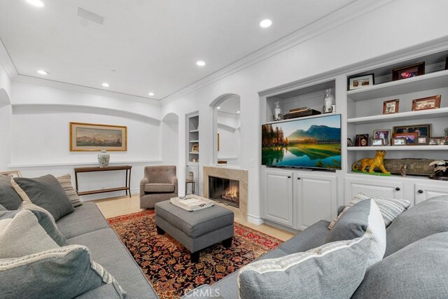 8 Saint Tropez, Laguna Niguel, CA 92677 - living area with built in features, ornamental molding, a fireplace, recessed lighting, and light wood-style floors