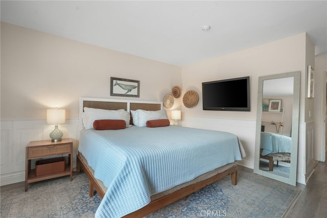 700 Esplanade Unit 9, Redondo Beach, CA 90277 - bedroom with wainscoting, wood finished floors, and a decorative wall