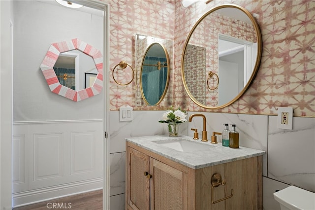 700 Esplanade Unit 9, Redondo Beach, CA 90277 - bathroom featuring wallpapered walls, vanity, toilet, and a wainscoted wall