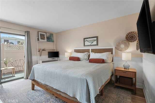 700 Esplanade Unit 9, Redondo Beach, CA 90277 - bedroom featuring access to exterior, wainscoting, and wood finished floors