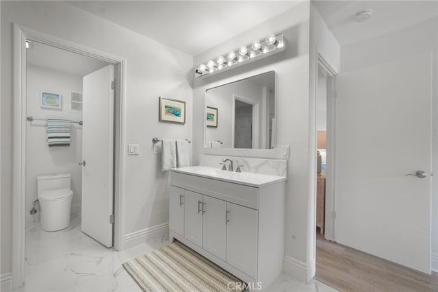 700 Esplanade Unit 9, Redondo Beach, CA 90277 - bathroom featuring marble finish flooring, vanity, toilet, and baseboards