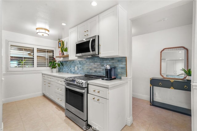 700 Esplanade Unit 9, Redondo Beach, CA 90277 - kitchen with stainless steel appliances, white cabinetry, light countertops, light tile patterned flooring, and tasteful backsplash