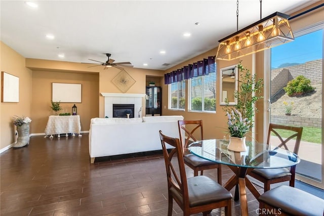15190 Fox Ridge Dr, Fontana, CA 92336 - dining space featuring a tile fireplace, dark wood-style flooring, a ceiling fan, baseboards, and recessed lighting