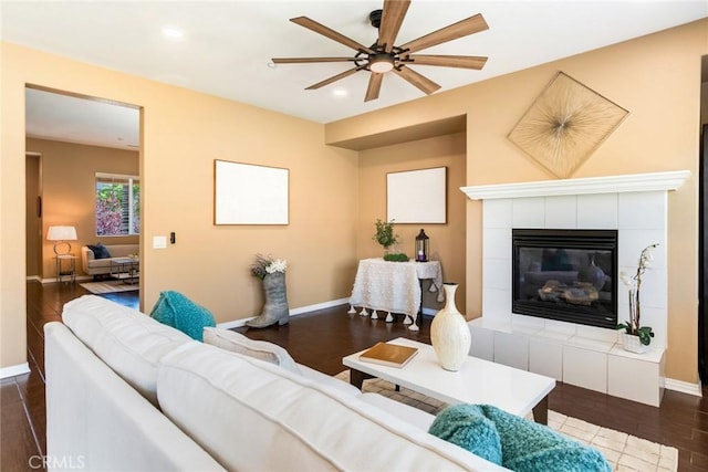 15190 Fox Ridge Dr, Fontana, CA 92336 - living room featuring a ceiling fan, baseboards, recessed lighting, dark wood-style floors, and a tiled fireplace