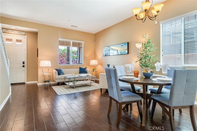 15190 Fox Ridge Dr, Fontana, CA 92336 - dining space featuring dark wood-style floors, a chandelier, and baseboards